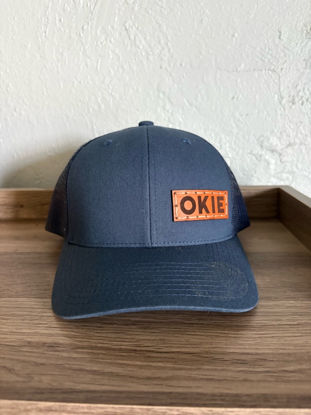 The Classic Navy Trucker Hat with Leather 'OKIE' Patch